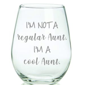 May include: A clear glass wine glass with the text "I'm not a regular aunt. I'm a cool aunt." printed on the side.