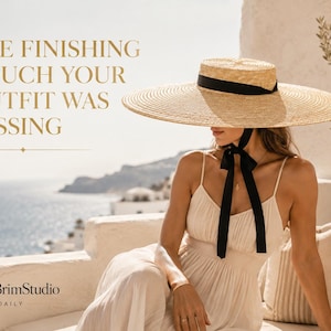 May include: A wide-brimmed straw hat with a flat crown and a black ribbon band that ties under the chin. The text on the image reads: THE FINISHING TOUCH YOUR OUTFIT WAS MISSING and ChicBrimStudio STYLE DAILY. The hat is light tan in color.