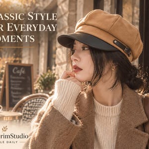 May include: A tan newsboy cap featuring a black brim and a decorative side strap with a metal buckle. The text "CLASSIC STYLE FOR EVERYDAY MOMENTS" and "ChicBrimStudio STYLE DAILY" is visible in the image along with a cafe setting background.