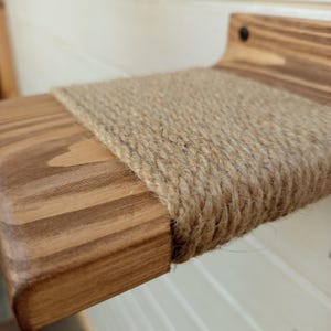 Close-up of rope-wrapped wooden cat step showing natural texture and handmade detail.