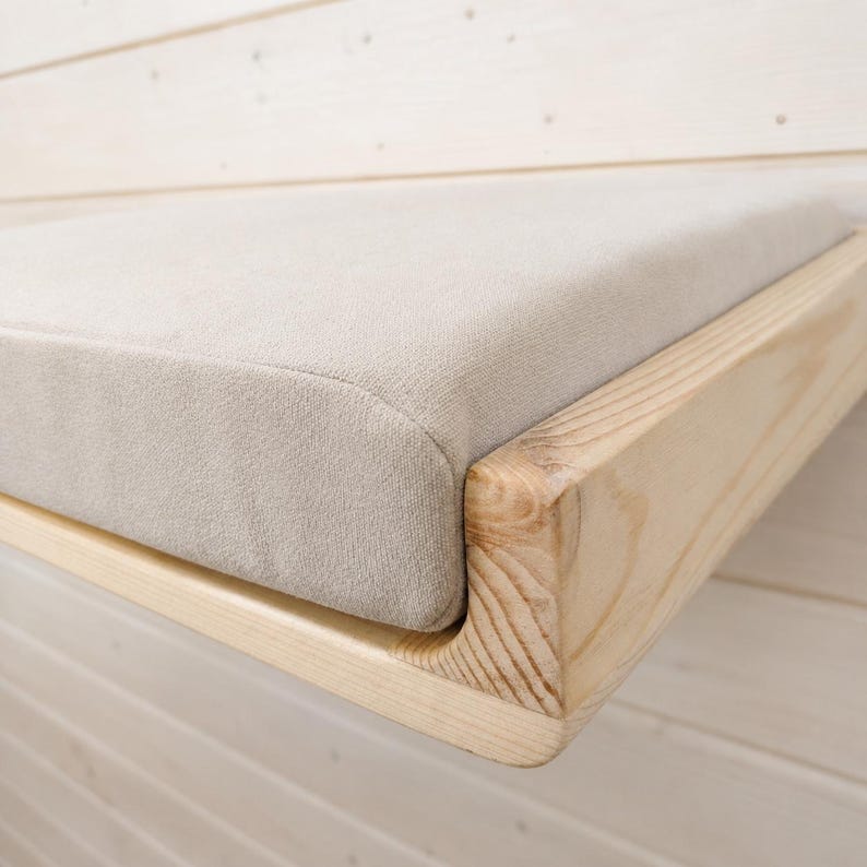Close-up of natural pine wood grain and smooth handmade edges on a wooden cat wall shelf.