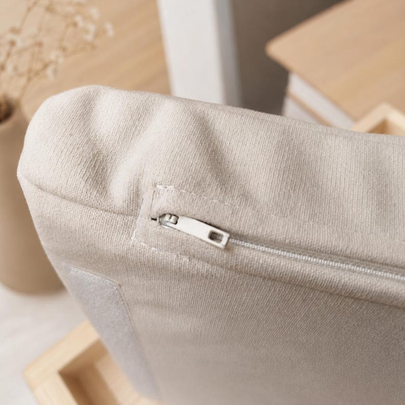 Close-up of the soft zippered cushion fabric on a handmade wall mounted cat bed.