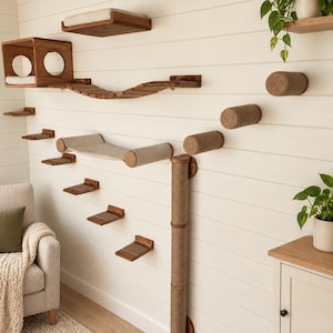 May include: A wall-mounted cat furniture system featuring a wooden box with circular cutouts, a suspended bridge, a fabric hammock, multiple carpeted steps, a tall vertical sisal-wrapped scratching post, and several cylindrical sisal perches.
