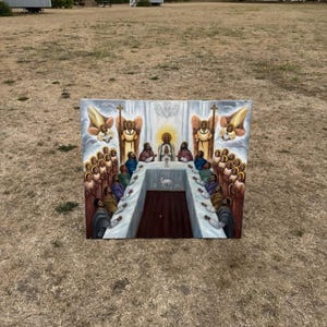 May include: A rectangular painting depicting a religious scene with a central figure surrounded by numerous individuals seated at a long table. The artwork features winged figures, a dove, and a lamb symbol, rendered in a palette of brown, white, and gold.