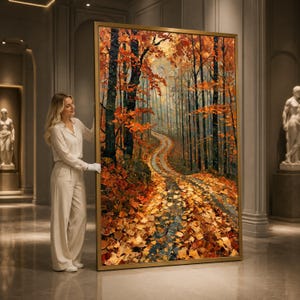 May include: A large rectangular framed oil painting depicting a forest path during autumn. The scene features tall trees with vibrant orange and yellow foliage, with a winding dirt trail covered in fallen leaves leading into the distance.