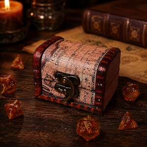 May include: A small wooden chest with a curved lid featuring a vintage map print labeled Oceanus Chinensis. The box has dark stained edges, a brass-colored metal latch, and is surrounded by several translucent amber-colored polyhedral dice.