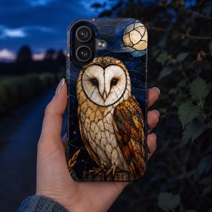 May include: A smartphone case featuring a detailed illustration of a barn owl with white and brown feathers. The background depicts a dark blue night sky with a glowing full moon and small golden stars, rendered in a stained glass art style.