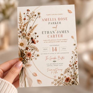 May include: A wedding invitation card featuring a dried wildflower bouquet illustration in shades of rust, cream, and brown. The text reads Amelia Rose Parker and Ethan James Carter, Saturday Sept 14 2029, at The Garden Bistro, 1250 Riverdale Road, Austin, Texas.
