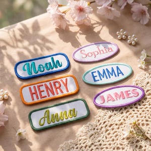 Pode incluir: Seis emblemas bordados com nomes, com centros de tecido branco e bordas coloridas. Os emblemas apresentam os nomes Noah em azul-petróleo, Sophia em rosa, Henry em laranja, EMMA em azul, JAMES em rosa e Anna em verde-limão, em várias fontes.