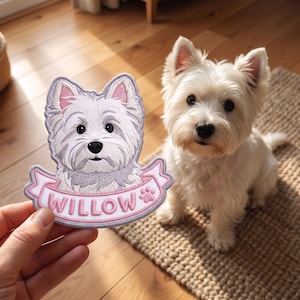 May include: An embroidered patch featuring a white West Highland White Terrier dog with pointed ears and a black nose. Below the dog, a pink banner contains the name WILLOW in white capital letters next to a small pink paw print icon.