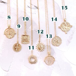 May include: A set of 10 gold necklaces with different pendants, including a sun, a moon, an eye, and a square. The necklaces are numbered 8 through 15.