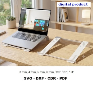 May include: A white laptop stand with a slotted design, shown supporting a silver laptop. The text digital product is visible in the corner. Below, the text reads 3 mm, 4 mm, 5 mm, 6 mm, 1/8", 1/6", 1/4" and SVG - DXF - CDR - PDF.