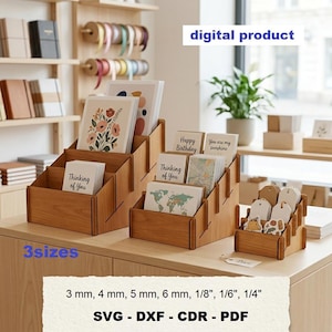 May include: Three tiered wooden display stands for greeting cards and tags, featuring a natural wood grain finish. The digital product includes files in 3 mm, 4 mm, 5 mm, 6 mm, 1/8 inch, 1/6 inch, and 1/4 inch sizes, available in SVG, DXF, CDR, and PDF formats.