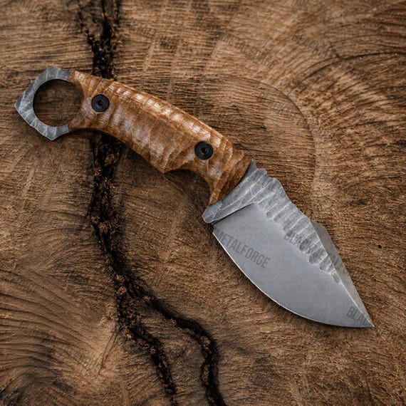 A blacksmith actually hammered this fixed blade from steel and fitted it with a walnut handle and ring pommel — it's a wearable piece of functional forge art.