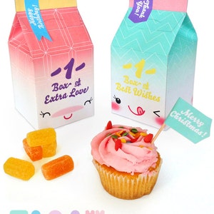 May include: Printable party favor boxes with cute cartoon faces and text that says "Box of Extra Love" and "Box of Best Wishes". The boxes are pink and blue with a gradient effect. There are also some orange candies and a cupcake with pink frosting and sprinkles.