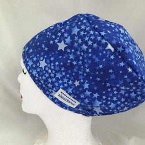 May include: Blue scrub hat with a white star pattern and the word "Sisterhood" embroidered on the side.