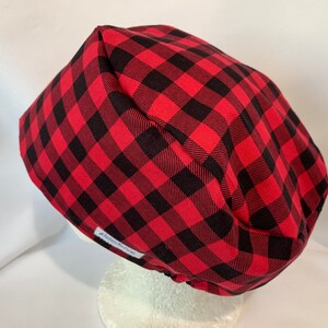 May include: Red and black buffalo plaid scrub hat with a white label that says "Handmade with Love".