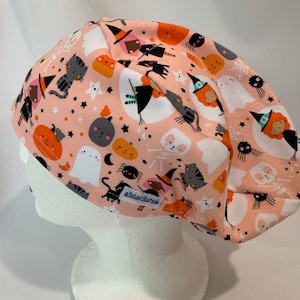 Snugfit KNIT Scrub Hat, peach Halloween super soft KNIT fabric 98 cotton/2 percent poly with Happy Halloween Characters