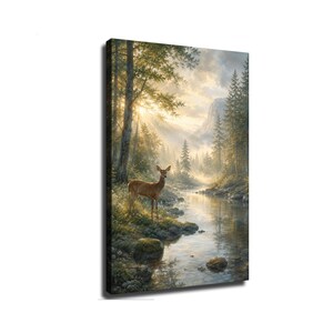 May include: A vertical canvas wall art print depicting a brown deer standing on the grassy bank of a calm river. The scene features a dense forest of pine trees, mossy rocks, and distant mountains under a bright, sunlit sky with soft rays.