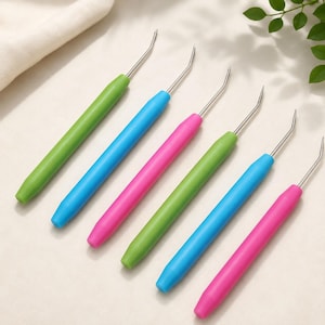 May include: A set of six craft tools with smooth, cylindrical handles in bright green, blue, and pink. Each tool features a thin, silver-colored metal shaft that extends from the handle and terminates in a small, upward-curved hook at the tip.