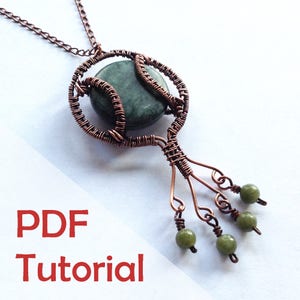 May include: A copper wire wrapped pendant with a green stone and green beads hanging from the bottom. The pendant is attached to a copper chain. The image includes the text "PDF Tutorial".