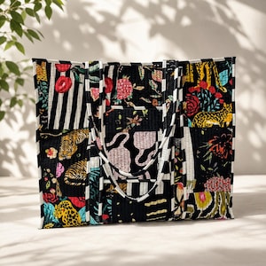 May include: A quilted tote bag featuring a patchwork design with black and white stripes, floral patterns, and animal prints including tigers and leopards. The bag has two matching striped handles and a rectangular shape with a black base color.