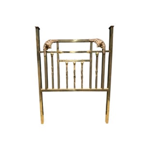 May include: A vintage brass headboard with a decorative design. The headboard features vertical bars, twisted metal accents, and ornate details at the top. The headboard is a warm gold color and has a classic, elegant style.