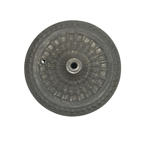 May include: A detailed, antique-style, silver-colored metal decorative furniture knob. The knob has a circular design with intricate patterns and a central hole for attachment. The knob is likely for a cabinet or drawer.