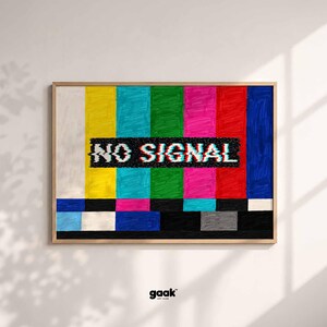 May include: A rectangular framed wall art piece featuring a hand-drawn style television test pattern with vertical stripes in white, yellow, cyan, green, magenta, red, and blue. A black horizontal bar displays the white text NO SIGNAL.