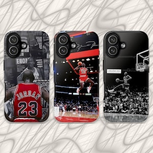 May include: Three black smartphone cases featuring Michael Jordan imagery. The left case shows a jersey back with number 23. The center case depicts a player jumping to dunk a basketball. The right case shows a black and white action shot.