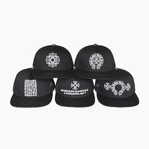 May include: Five black trucker hats arranged in a pyramid formation. Each hat features a white graphic print, including the Chrome Hearts logo, a cross emblem, and text reading Chrome Hearts Made In Hollywood California and Hollywood USA.