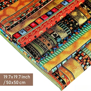 May include: A stack of folded fabric squares featuring intricate geometric patterns in vibrant red, gold, green, and blue. Each piece measures 50 by 50 cm. The textiles display repeating square motifs, ornate borders, and metallic gold accents.
