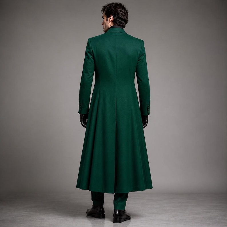 May include: A floor-length, dark green coat with long sleeves and a structured collar. The garment features a fitted bodice that transitions into a flared, pleated skirt section, extending down to the ankles. The coat is worn with black gloves.