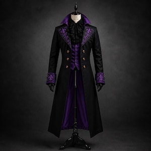 May include: A long black coat with a high collar, featuring purple lapels and cuffs embroidered with fleur-de-lis patterns. The coat is worn over a purple vest and a black ruffled cravat. The garment is displayed on a black mannequin stand.