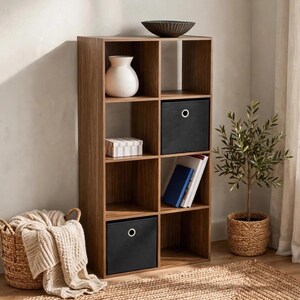 May include: A tall, brown wood-grain finish storage unit with eight open cubby compartments. Two black fabric storage bins with silver grommet handles are inserted into the cubbies. The unit holds a white vase, a striped box, and books.