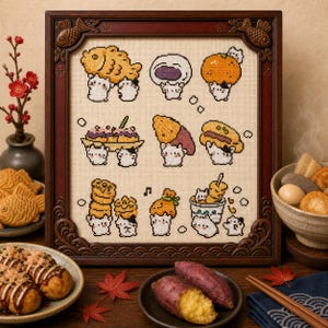 May include: A framed cross-stitch embroidery on beige fabric featuring nine distinct illustrations of small white cats interacting with various Japanese food items, including taiyaki, mochi, an orange, and skewered snacks, set in a dark wood frame.