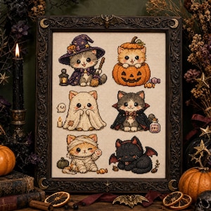 May include: A framed cross-stitch embroidery featuring six kittens in Halloween costumes: a witch with a lantern, a pumpkin, a ghost, a vampire with a potion bottle, a mummy, and a black bat-winged cat, all set against a light fabric background.