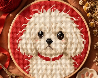 May include: A circular wooden embroidery hoop containing a cross-stitch pattern of a fluffy white dog with dark brown eyes and a black nose. The dog is centered against a solid red background and wears a red collar. The design is detailed and textured.