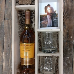 May include: A wooden gift box with a bottle of Glenmorangie Original Single Malt Scotch Whisky, two clear glasses, and a photo of a couple.