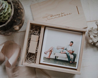 May include: A wooden box with a photo print of a couple sitting on a couch. The box also contains a wooden USB drive and a piece of brown paper. The lid of the box has the text "Waiting for Tennessee" engraved on it.