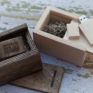 May include: Two wooden boxes with USB drives inside. The box on the left is dark brown with the text "BACIO PHOTOGRAPHY" engraved on the drive. The box on the right is light brown with a plain USB drive inside.