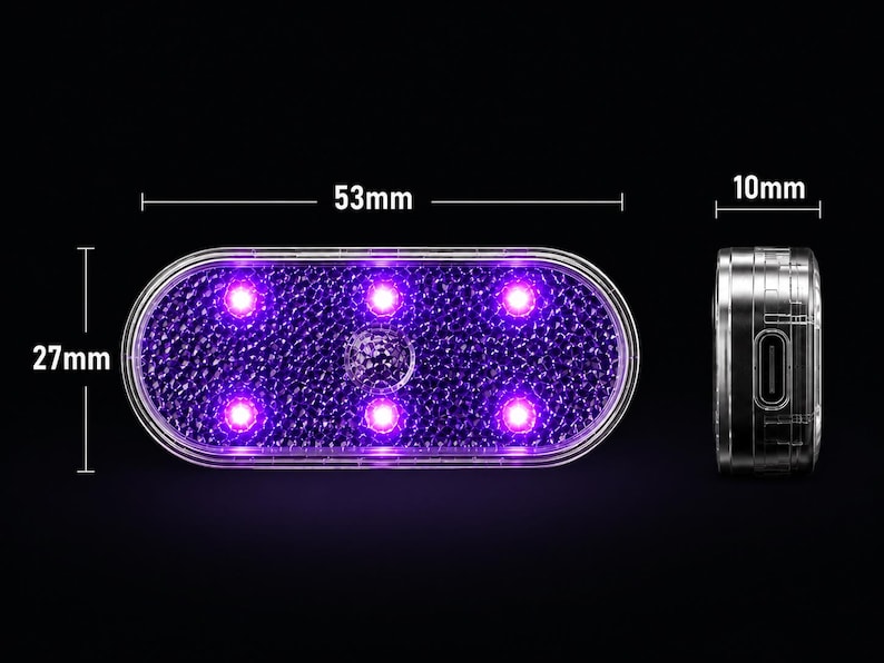 May include: An oval-shaped light with a textured surface emitting a purple glow from six internal points. The device measures 53mm in length, 27mm in height, and 10mm in depth, featuring a side port for charging or connectivity.