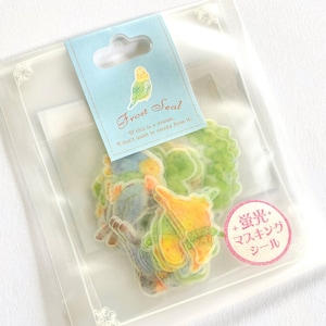 May include: A clear plastic bag with a colorful sticker sheet inside. The sticker sheet features a variety of small, colorful birds and plants. The bag has a label that reads "Frost Seal" and "If this is a dream, I don't want to awake from it." The label also has a small image of a bird. The sticker sheet is labeled "+螢光+ マスキング シール" which translates to "+Fluorescent+ Masking Tape".