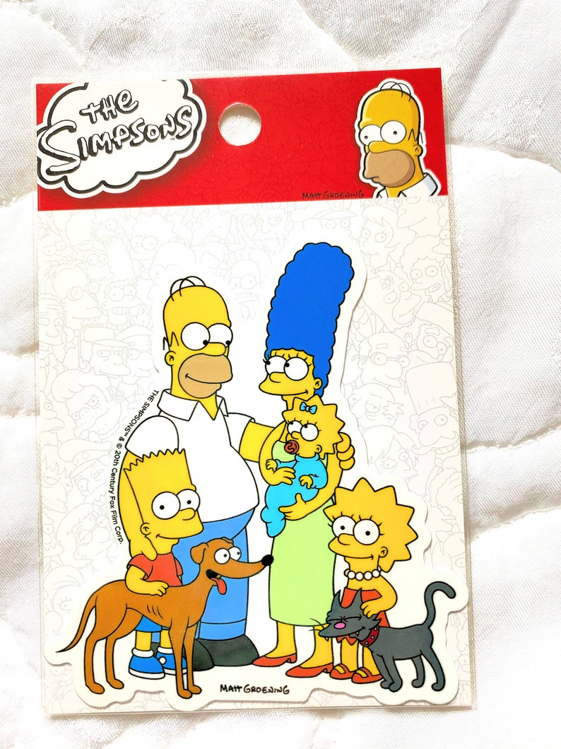 May include: A sticker sheet featuring the Simpsons family. The characters are Homer, Marge, Bart, Lisa, Maggie, Santa's Little Helper, and Snowball. The sticker sheet is white with a black outline and the text "The Simpsons" and "Matt Groening" in black.