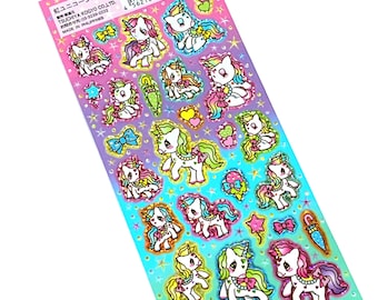 May include: A sheet of colorful unicorn stickers with glitter accents. The stickers feature unicorns with rainbow manes and tails, bows, and hearts. The sheet is on a pink and blue background with stars.