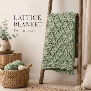 May include: A sage green knitted blanket with a textured lattice pattern draped over a wooden ladder. The text LATTICE BLANKET Knitting pattern is visible. A woven basket containing balls of green and white yarn sits nearby on a wooden surface.