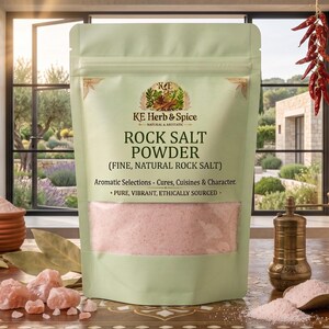 May include: A light green stand-up pouch of KE Herb & Spice Rock Salt Powder, featuring a clear window showing pink salt. The label reads Rock Salt Powder (Fine, Natural Rock Salt), Aromatic Selections - Cures, Cuisines & Character, Pure, Vibrant, Ethically Sourced.