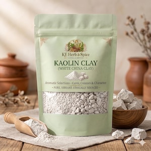May include: A light green stand-up pouch of KE Herb & Spice Kaolin Clay, also labeled as White China Clay. The packaging features a clear window displaying white clay chunks and powder, with text including Aromatic Selections and Pure, Vibrant.