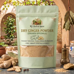 May include: A light green stand-up pouch of KE Herb & Spice Dry Ginger Powder. The label features the text Dry Ginger Powder (Zingiber Officinale), Aromatic Selections, and Pure, Vibrant, Ethically Sourced. The pouch has a clear window.