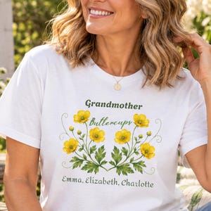 名入れおばあちゃんシャツ、孫の名前入りTシャツ、カスタムおばあちゃんフラワーシャツ、ナナ・ミミ・ジジギフト、ボタニカルコンフォートカラーズTシャツ